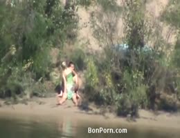 un voyeur film un couple faire l'amour au bord de l'eau